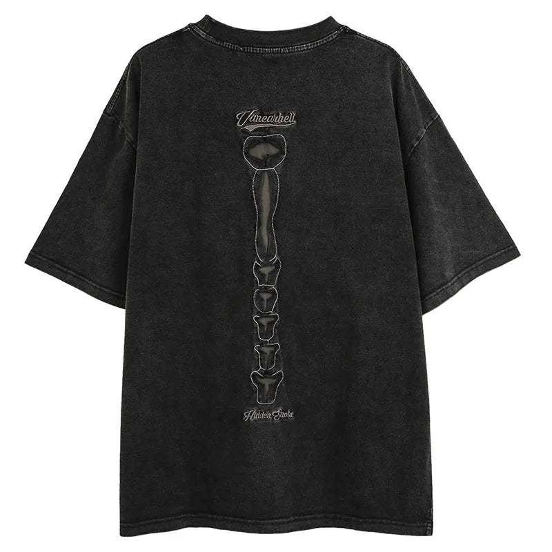 A man's black loose-fit cotton t-shirt with a skull and letter graphic print and drop-shoulder sleeves.