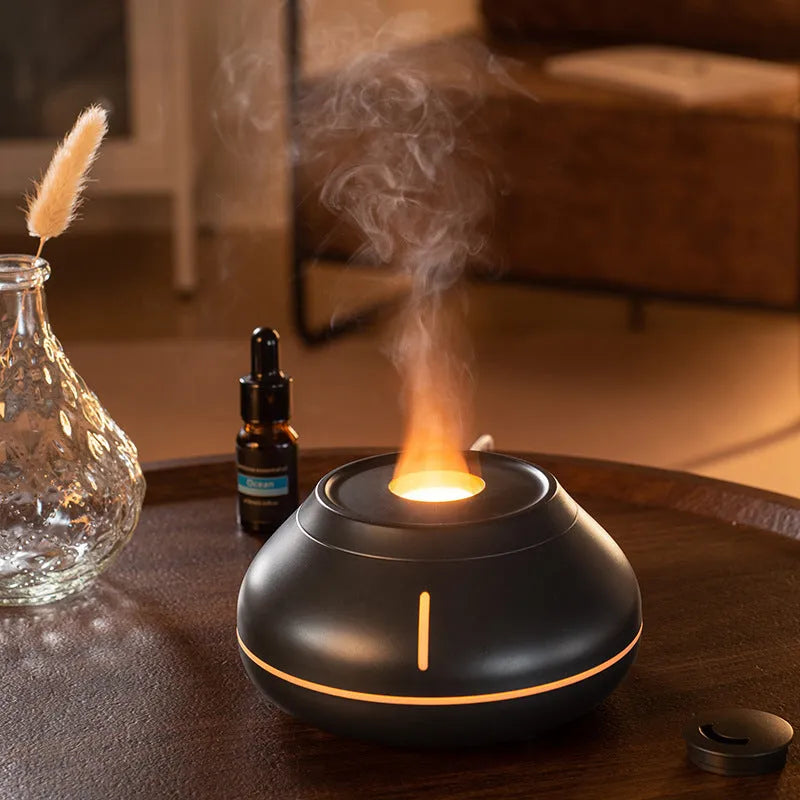 Round aromatherapy diffuser with LED flame simulation effects in black, cracked black or white colour options