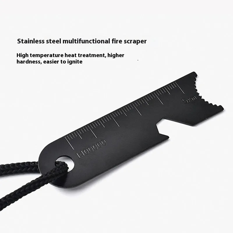 Black outdoor multifunctional survival flint tool with stainless steel scraper on a dark background.