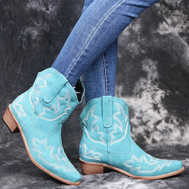Women's blue embroidered cowboy boots with a low wedge heel and pointed toe.
