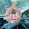Hand-woven wool bell orchid car pendant hanging, shown in green, pink, purple and yellow colour variants.