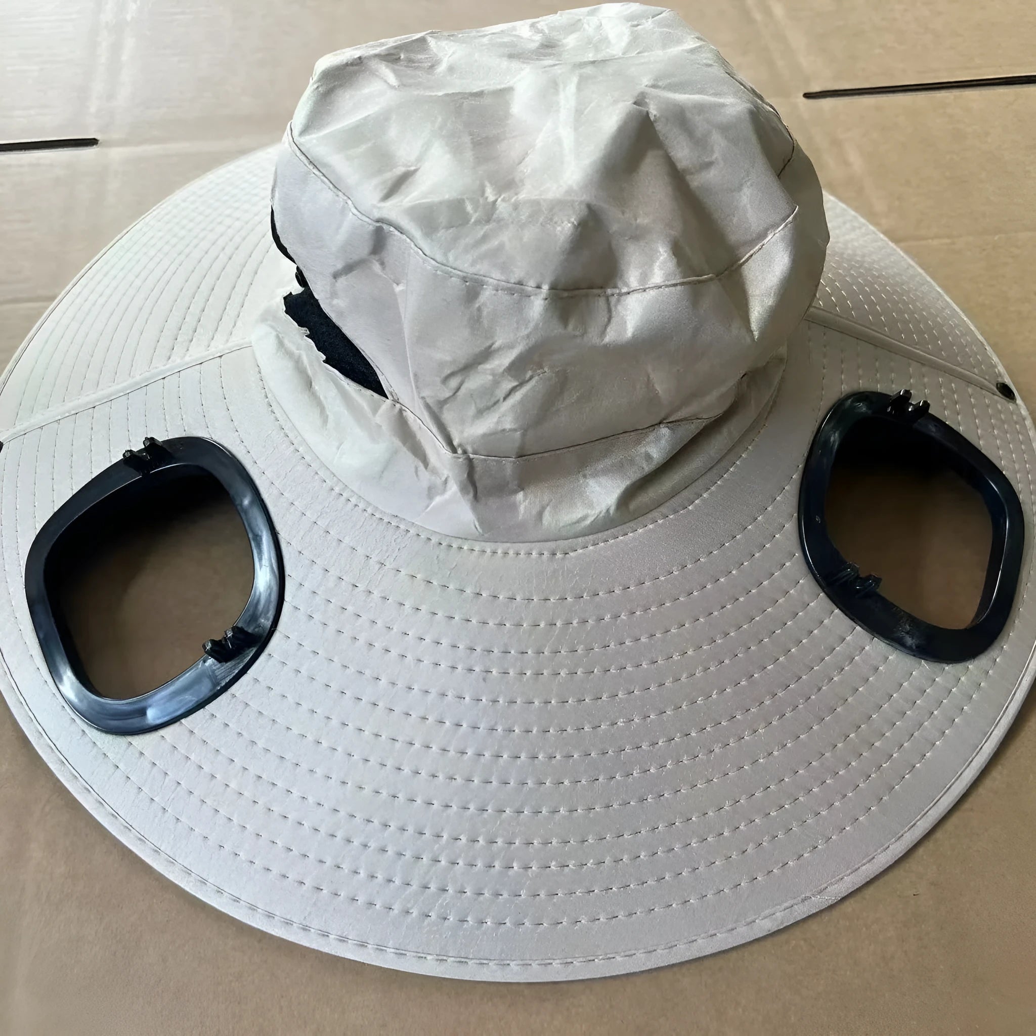 Men's grey solar fan cap with wide brim showing integrated cooling system