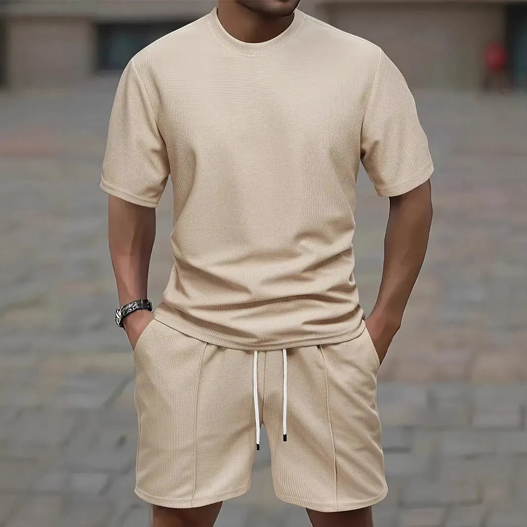 Man wearing a white waffle texture short sleeve blouse and matching shorts summer set.
