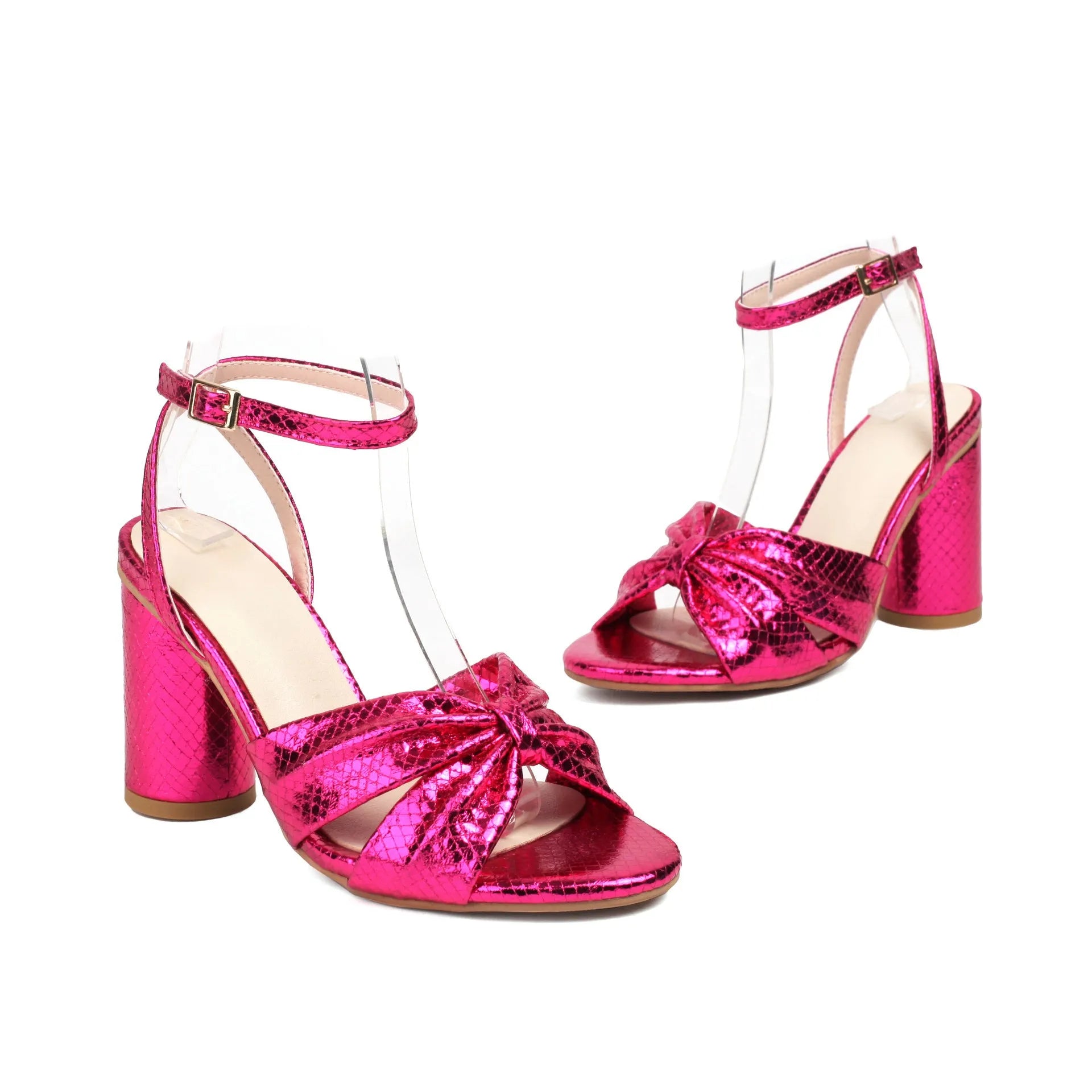 Gold high heel peep toe sandal with ankle buckle on a white background