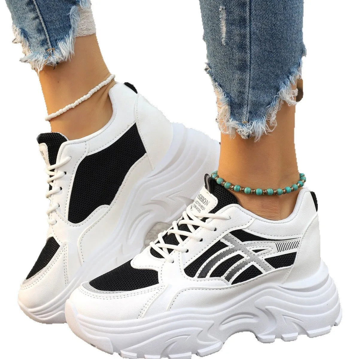 Women's platform wedge sneakers in black or white with mesh lining, rubber sole, front lace-up, round toe, and sewing thread detail.