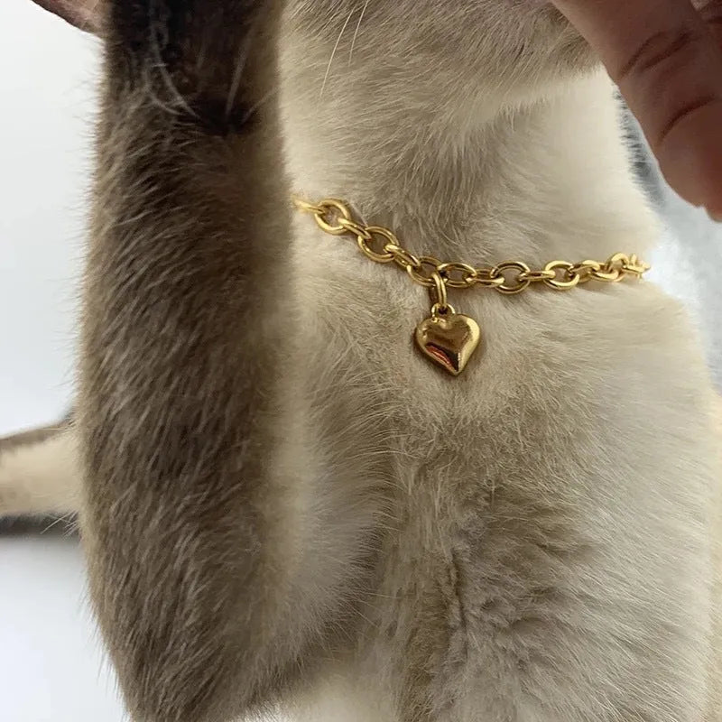 Stainless steel curb chain necklace with a detailed love heart pendant, shown in gold and silver finishes.