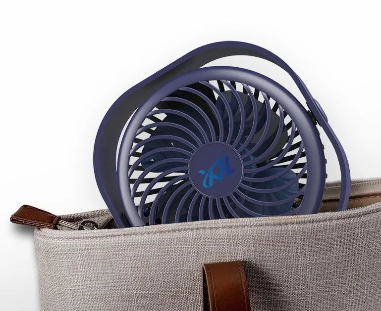 Pink USB desk fan with 360-degree rotating head on a white desk.