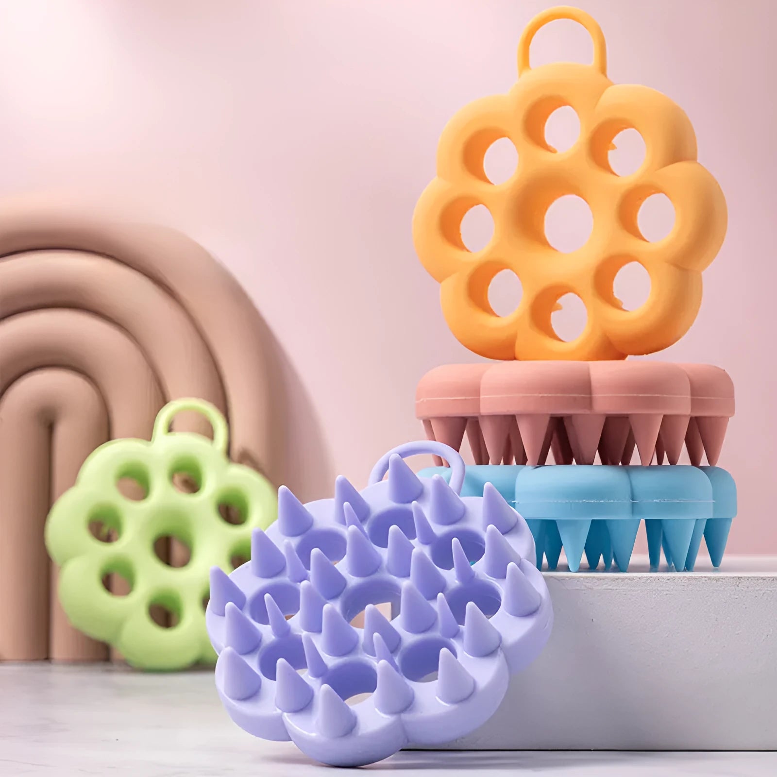 Silicone pet grooming brush with coloured ergonomic handle and flexible massage bristles for dogs and cats.