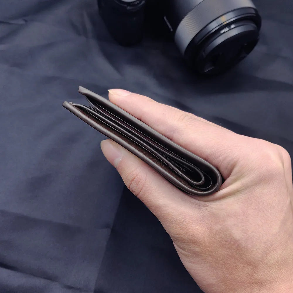 Men's leather wallet showing seven card slots and zipper closure mechanism