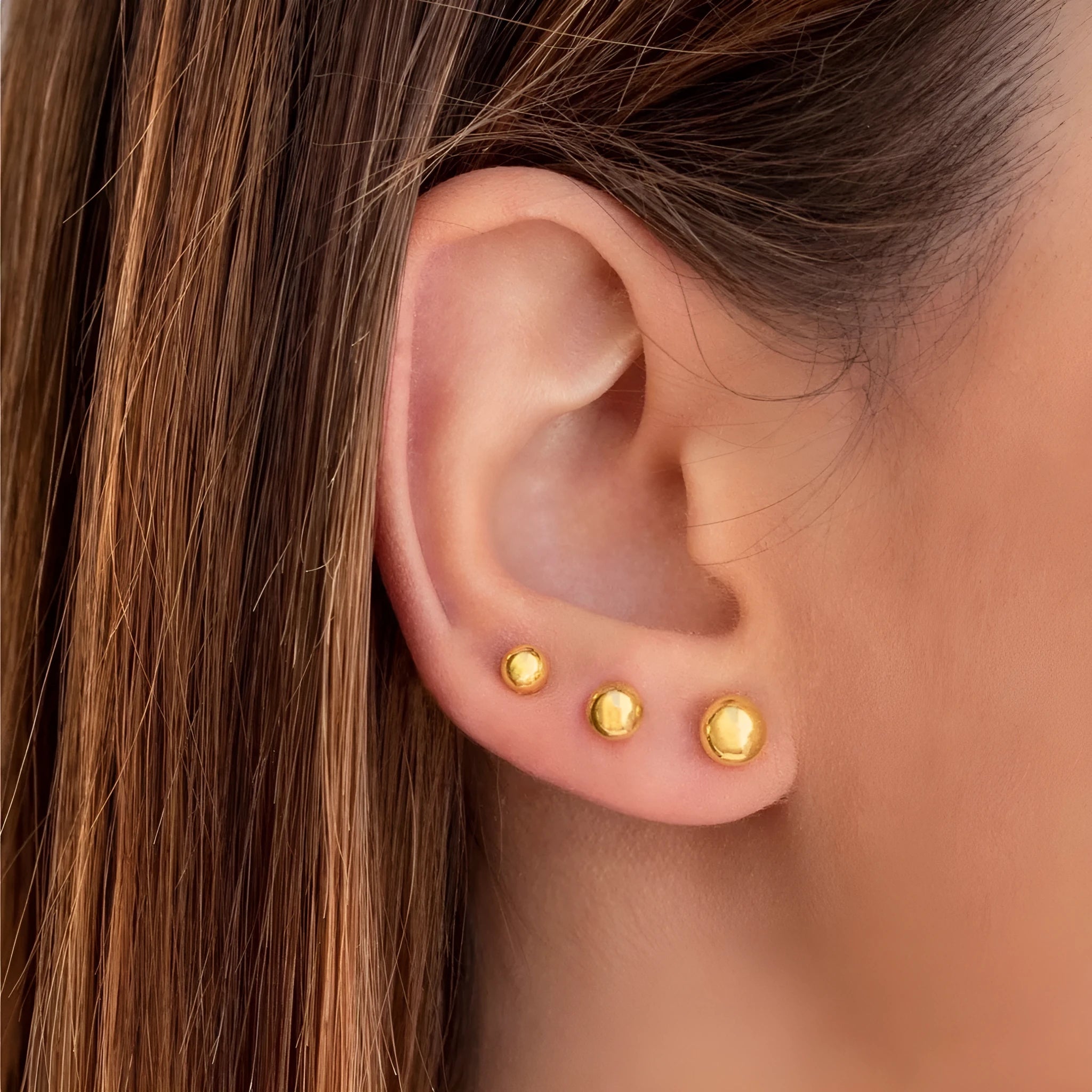 Stainless steel ball stud earrings in gold or silver finish, showing 3mm, 4mm, 5mm, and 6mm size options.