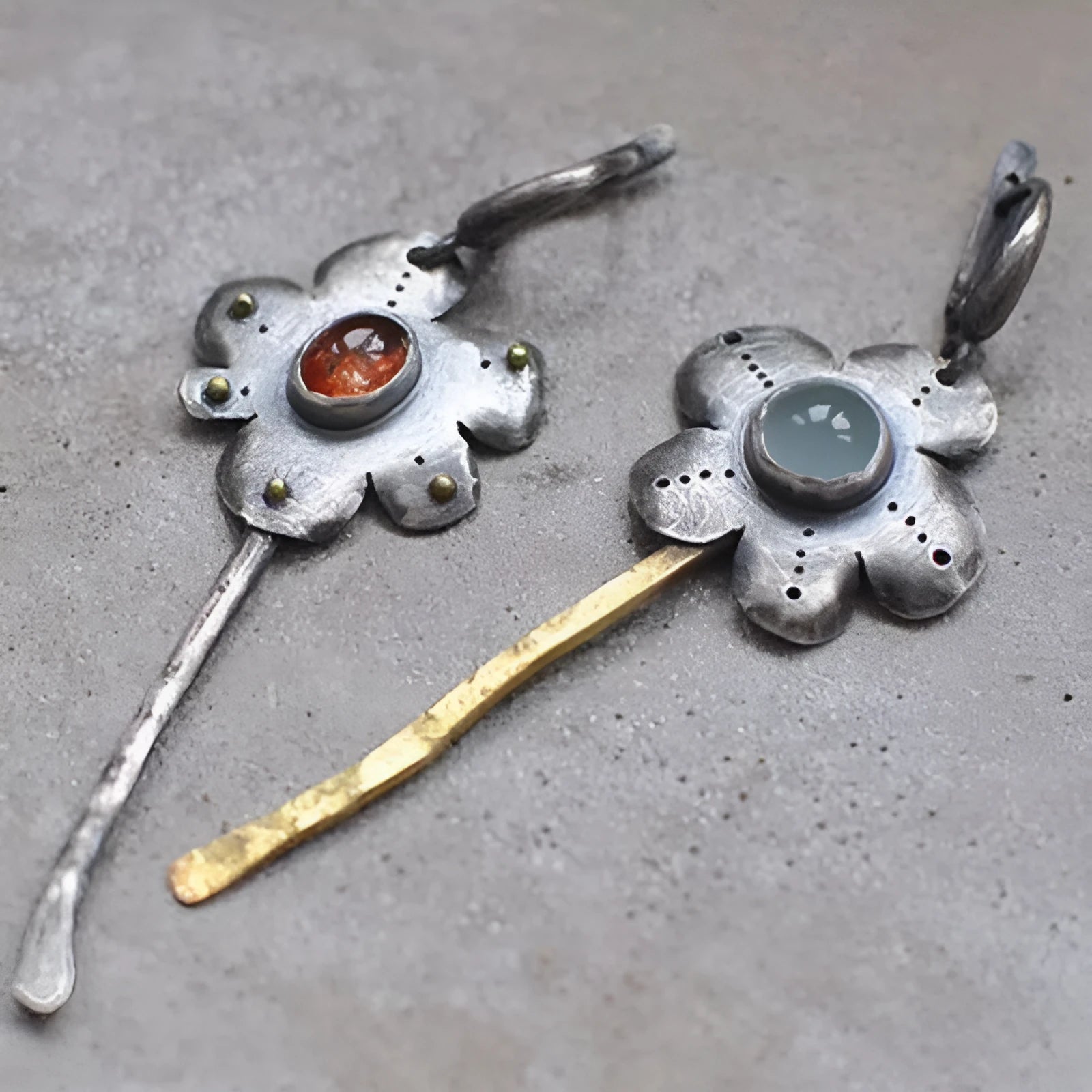 A pair of long, geometric flower-shaped retro earrings in two contrasting metallic colours with an asymmetrical design.