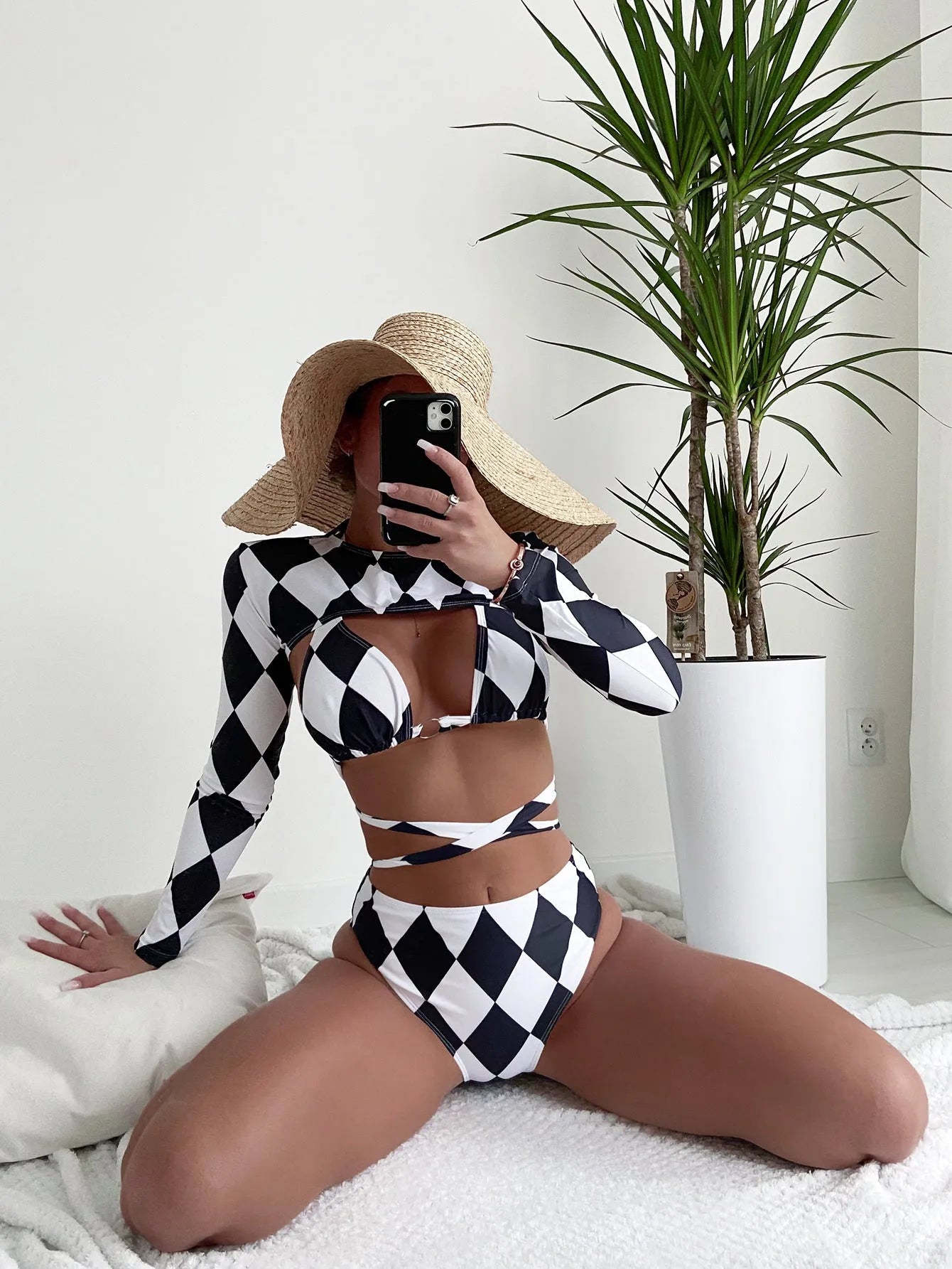 Ladies plaid patterned long sleeve three-piece bikini swimsuit set on a white background.