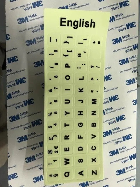 Yellow glowing keyboard stickers showing Arabic, Thai, Hebrew, French, Italian and German characters on PVC sheet