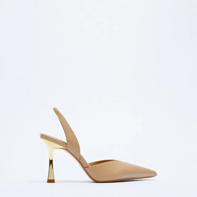 Women's nude apricot pointed toe patent leather high heels on a white background.