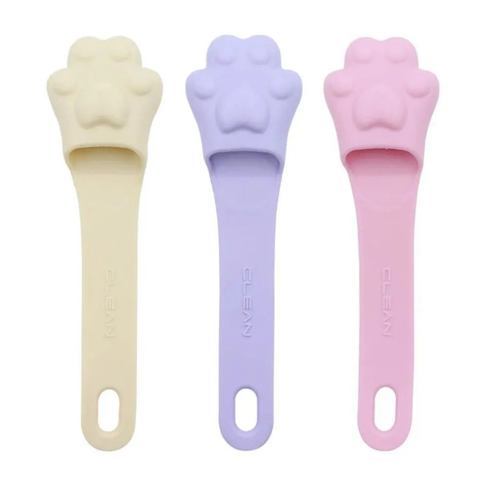 Pink silicone finger toothbrush for dogs and cats with soft nubby bristles.