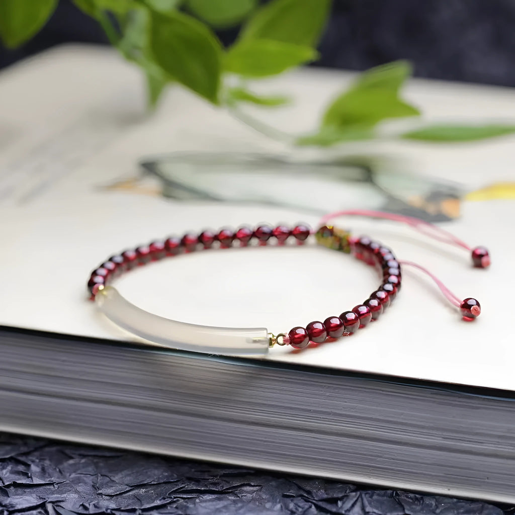 Adjustable red garnet and agate beaded bracelet with pull bead closure on wrist