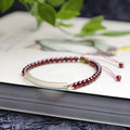 Adjustable red garnet and agate beaded bracelet with pull bead closure on wrist