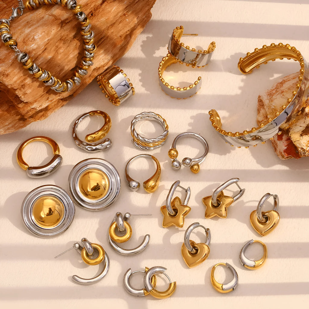 Gold geometric jewellery set for women featuring earrings, bracelet, and necklace on a white background.