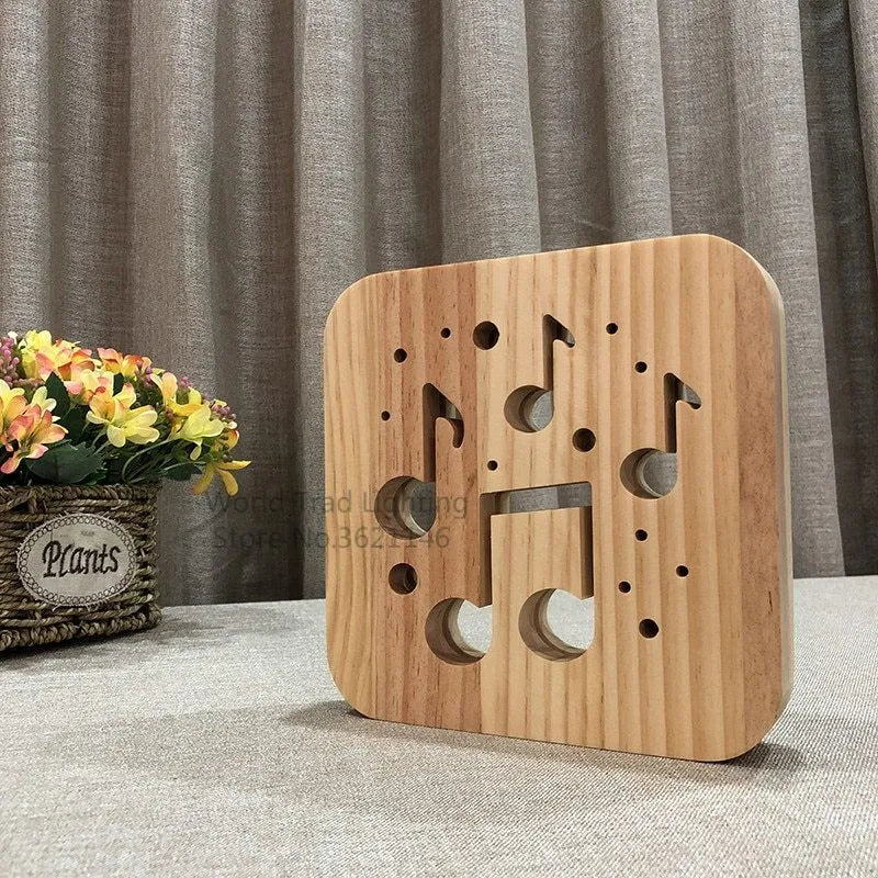 Square pine wood USB-powered LED lamp emitting warm white 3D light on a table.