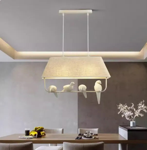 Bird chandelier ceiling lamp with iron frame and fabric shade in dining room setting