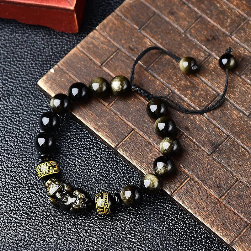 Original hand-woven golden obsidian Pi Xiu bracelet showing bead detail and Chinese style design