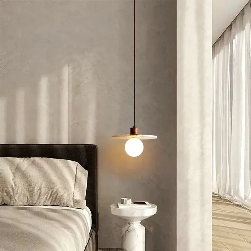 Yellow cave stone wabi sabi style marble bedside pendant light on a wooden surface