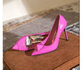 Pink women's patent leather pointed toe stiletto high heels with a buckle on the strap.