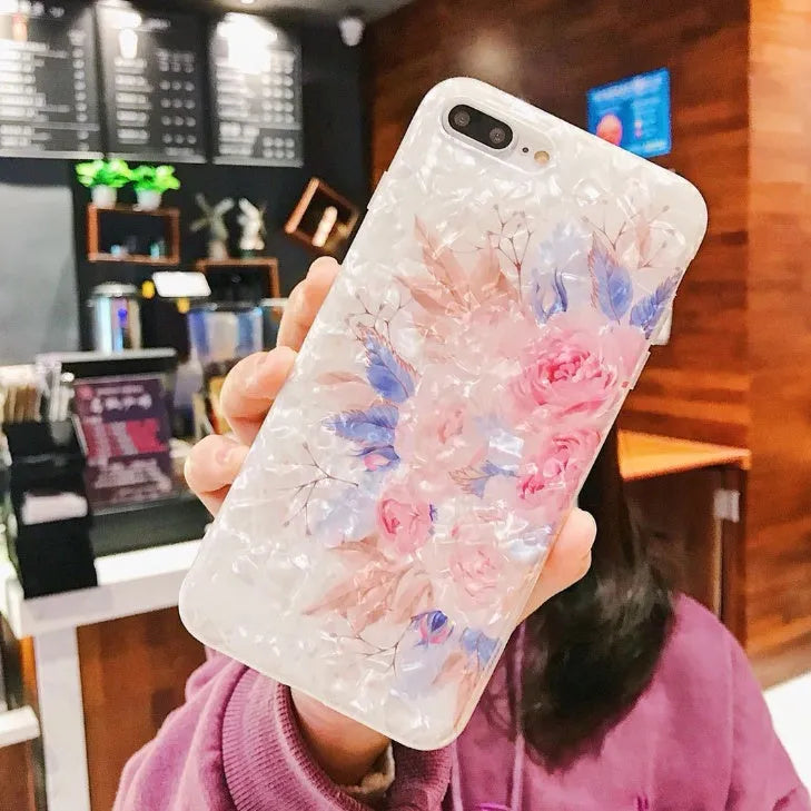 Dream Shell soft TPU silicone iPhone case with a rose flower design on the back, shown in brown colour.