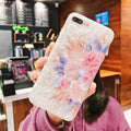 Dream Shell soft TPU silicone iPhone case with a rose flower design on the back, shown in brown colour.