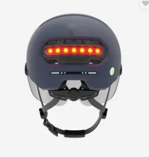 Adult cycling helmet with integrated red LED tail light on the back, shown in M and L sizes.