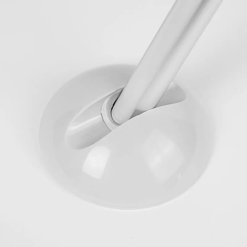 White LED cabinet night light unit with remote control on a table.
