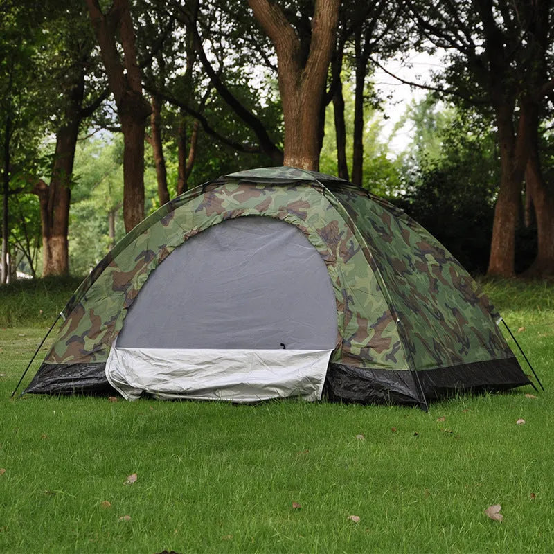 Green and brown camouflage pattern two-person camping tent with mesh windows, shown pitched outdoors.