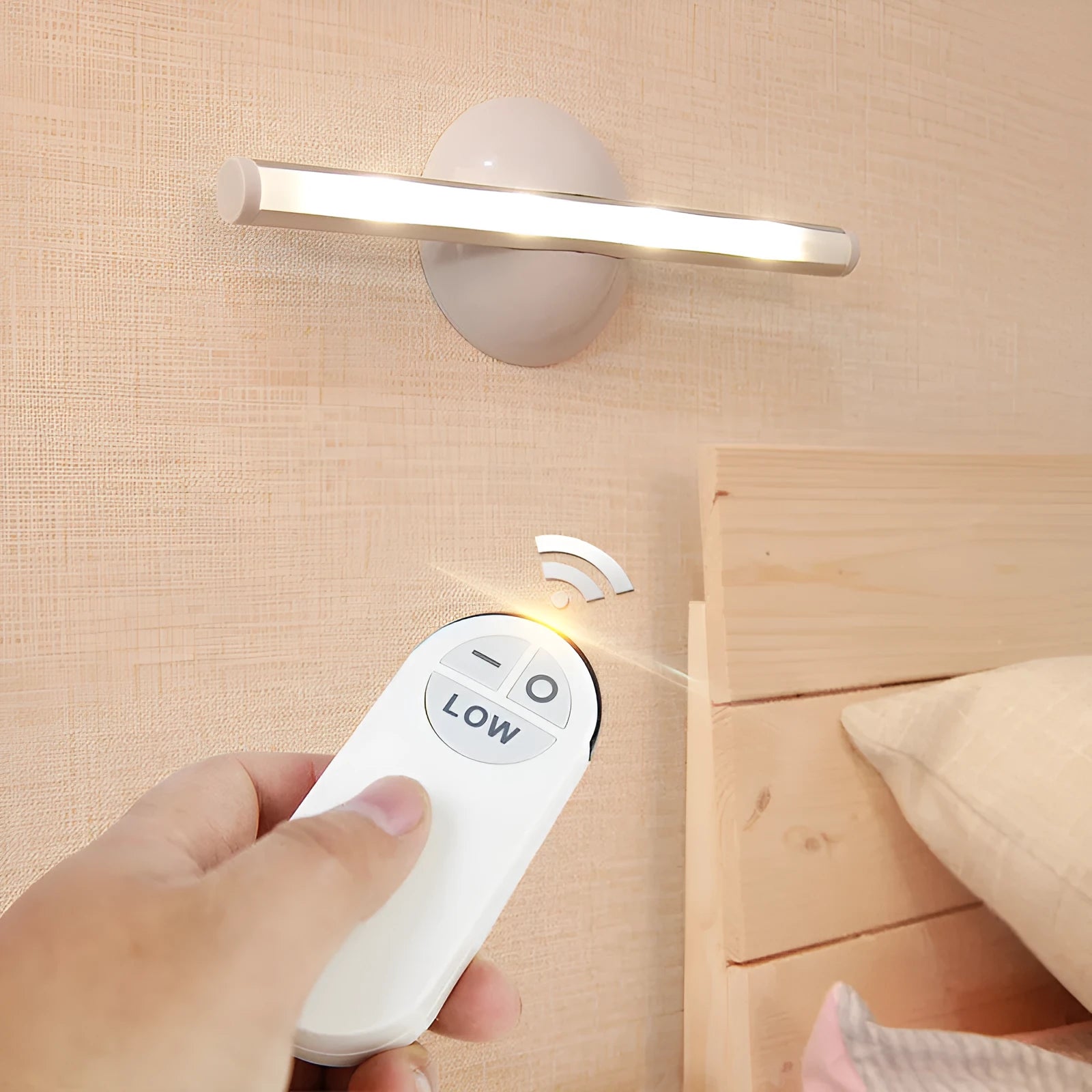 White LED cabinet night light unit with remote control on a table.