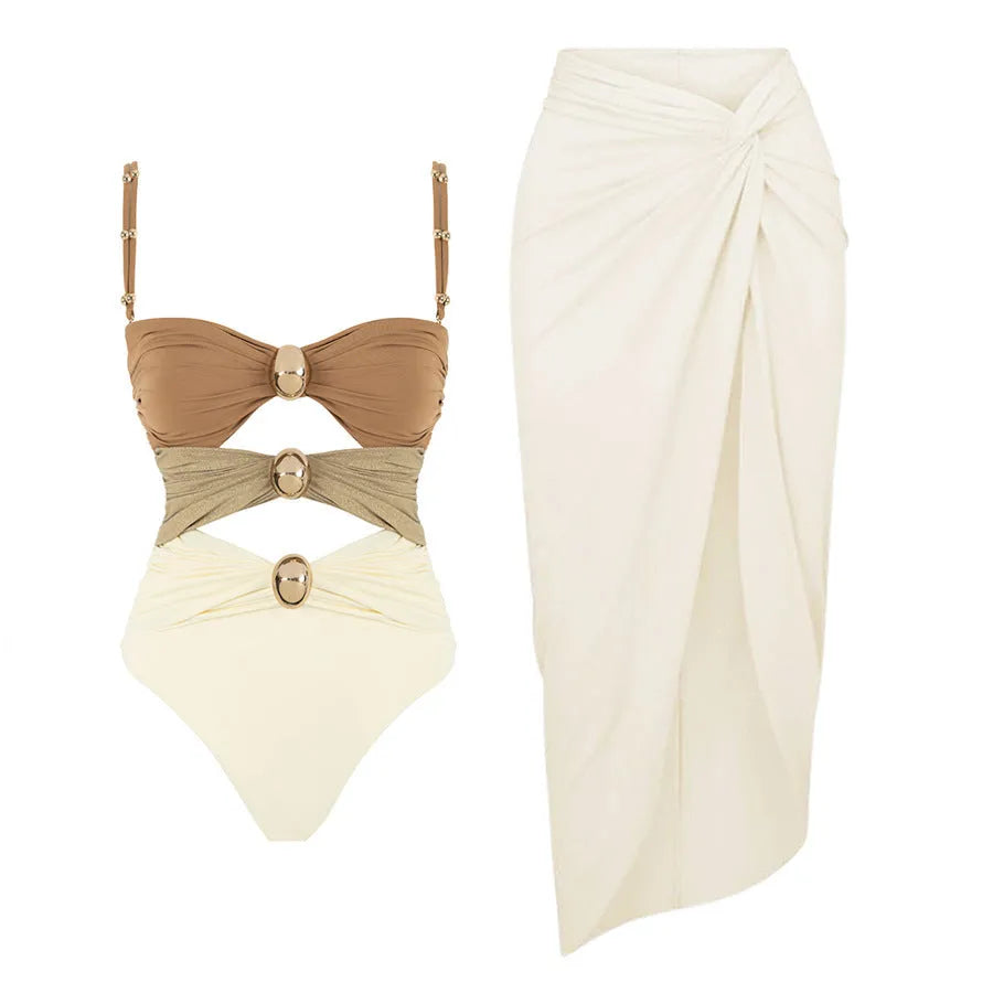 Women's black one-piece swimsuit with a detachable skirt and a gold button detail on the front