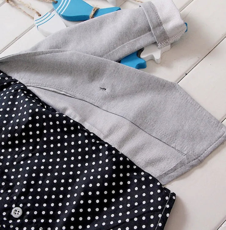 Blue children's cotton blend tracksuit set with zip-up hooded jacket and elasticated waist trousers laid flat.