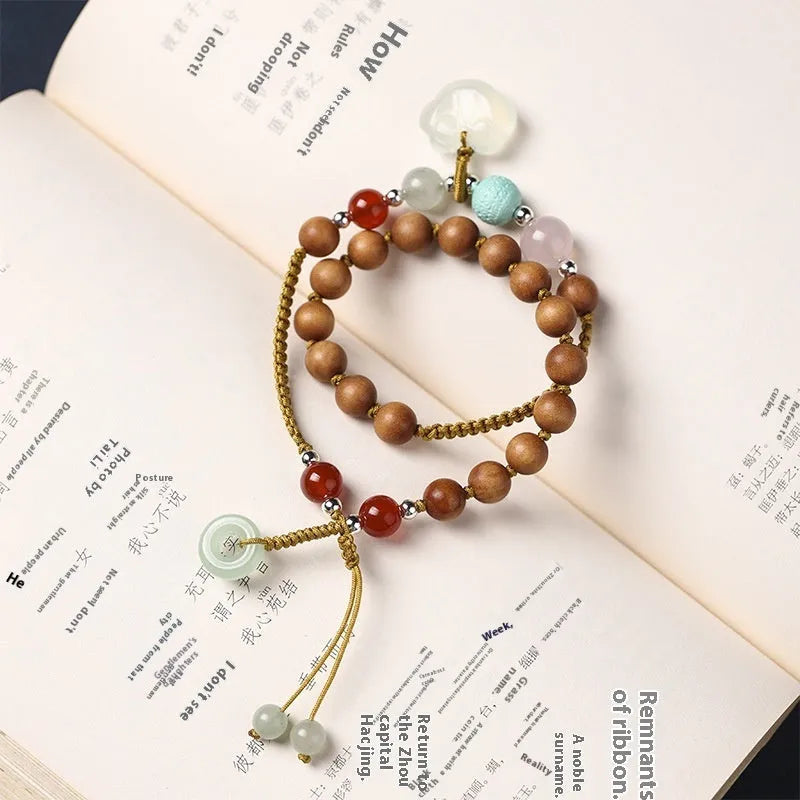 Women's hand-woven ebony double ring bracelet with traditional Ruyi motifs in Xiuyan jade or antique chalcedony