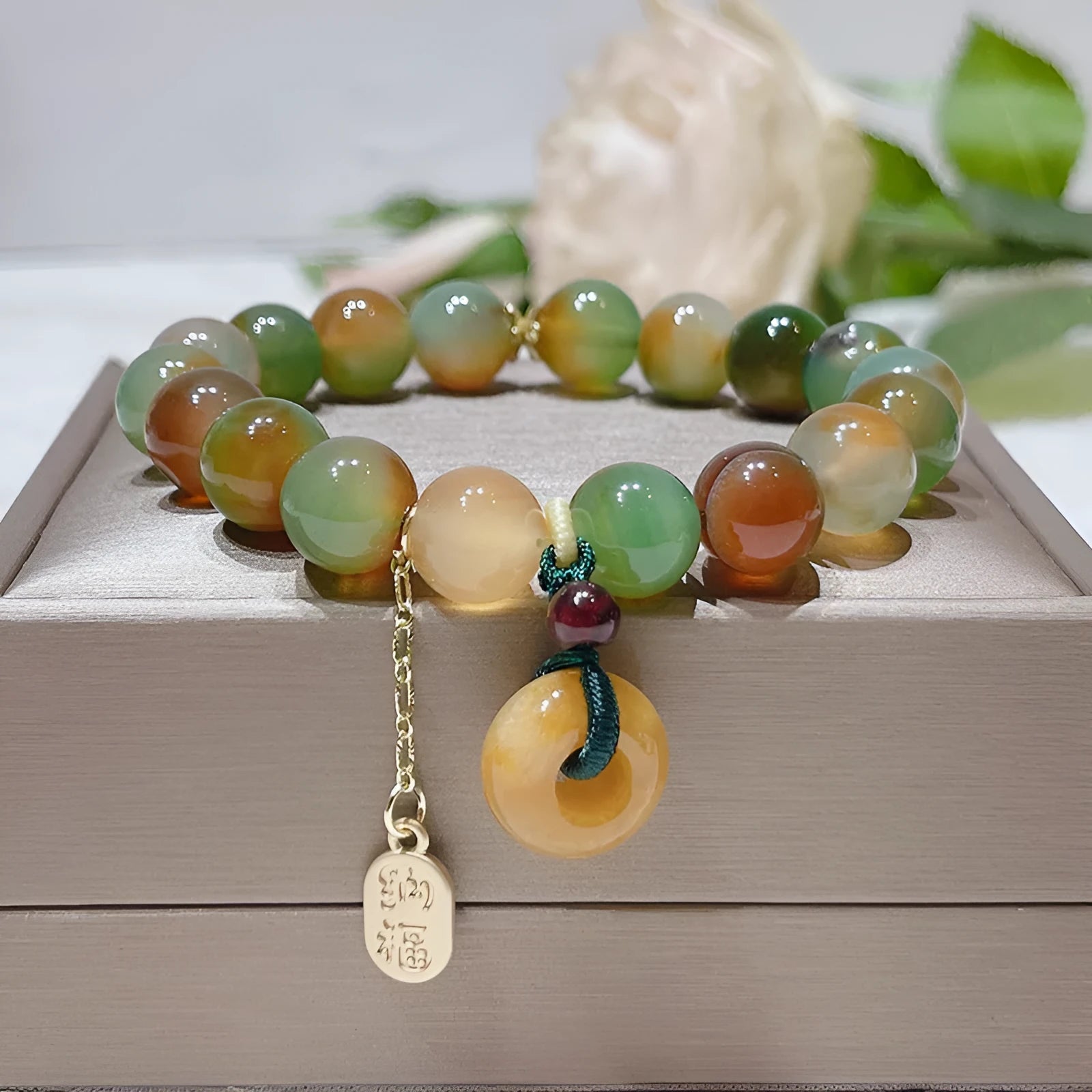 Yellow gold tone peacock agate and old mine topaz bracelet with peace buckle closure