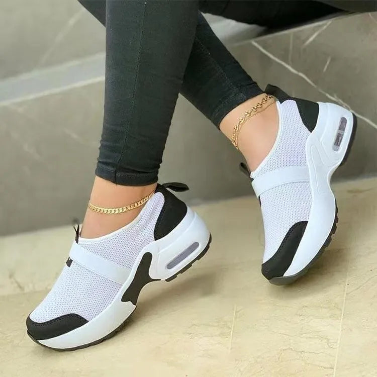 Women's lightweight flat sneakers with mesh upper, round toe, and rubber sole in multiple colour options.