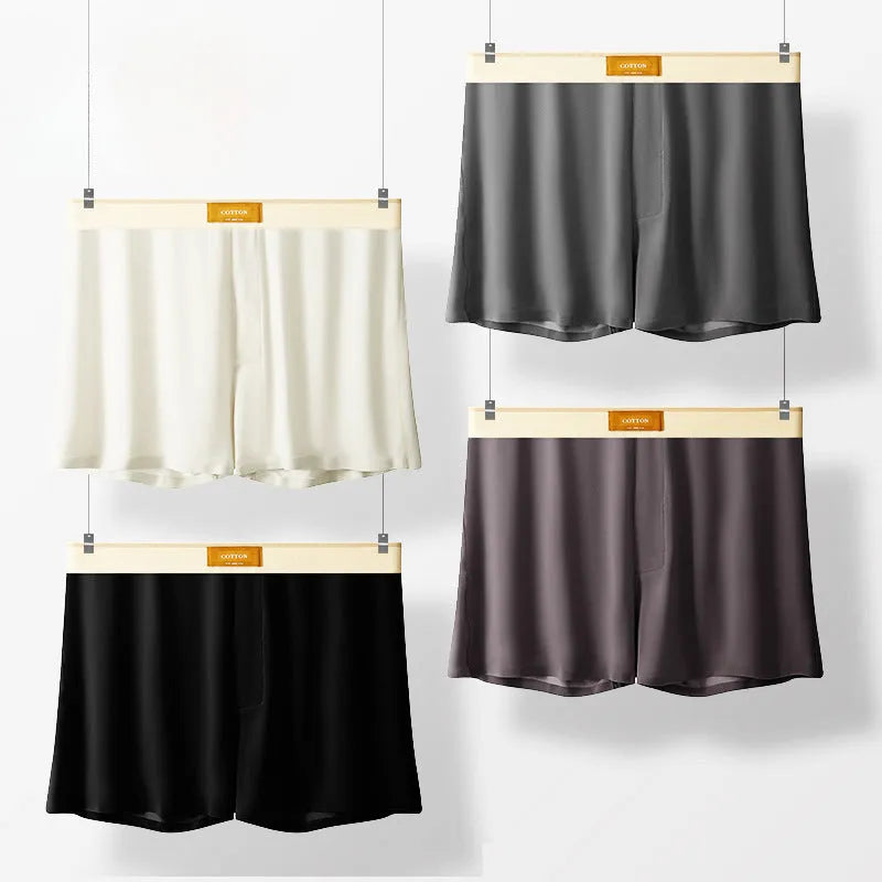 Pack of three men's solid colour loose fit ice silk boxer shorts on a white background