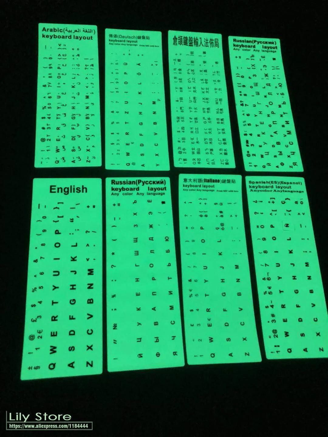 Yellow glowing keyboard stickers showing Arabic, Thai, Hebrew, French, Italian and German characters on PVC sheet