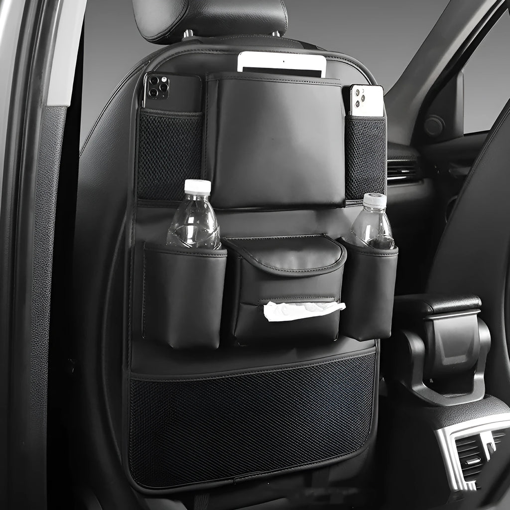 Leather car seat back storage bag in black, suspended behind a car headrest.