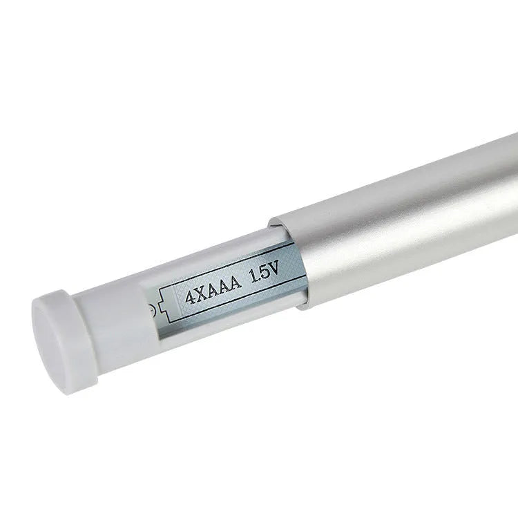 White LED cabinet night light unit with remote control on a table.