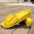 Women's grey blue EVA slippers with a buckle strap and soft sole on a white background