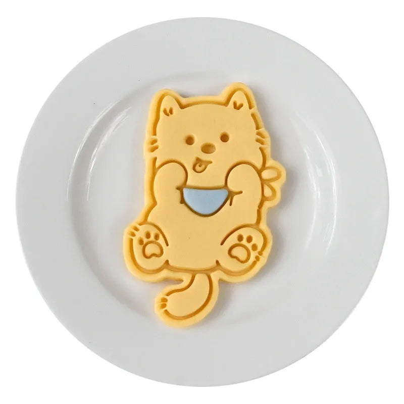 Plastic biscuit mould with puppy head designs including birthday hats and swimming rings