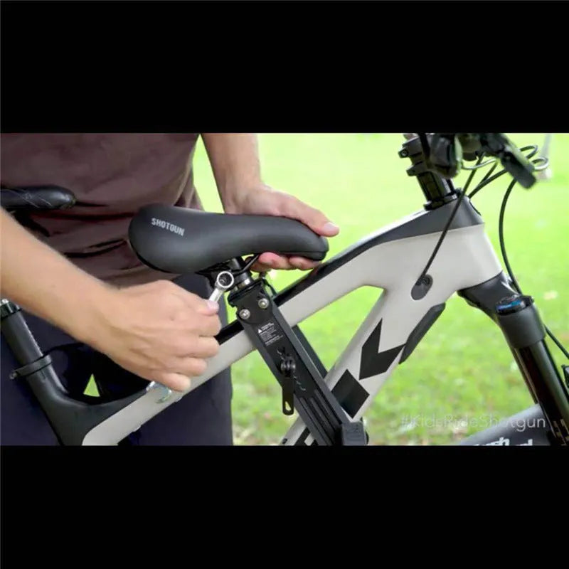 Black front-mounted kids bike seat on a mountain bike with quick-release attachment and rubber protection
