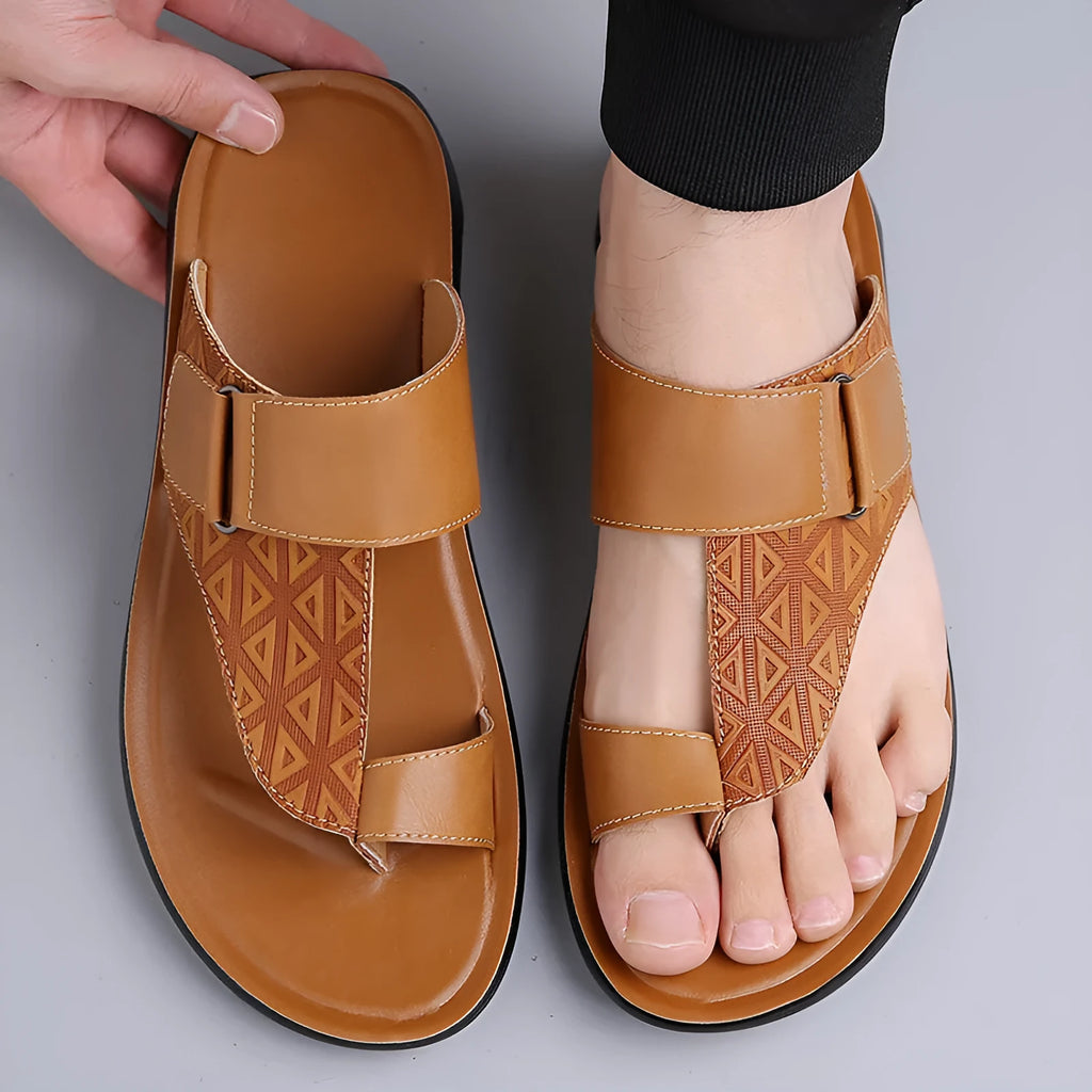Men's simple beach slippers in light brown cowhide with a rubber sole, shown from the side.