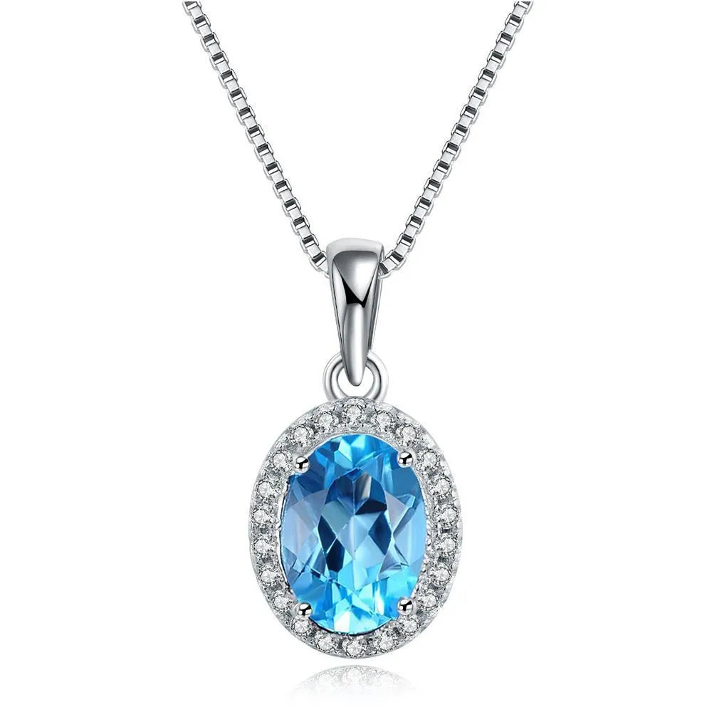 925 sterling silver four-piece jewellery set with blue topaz gems showing geometric earrings, ring, necklace, and pendant