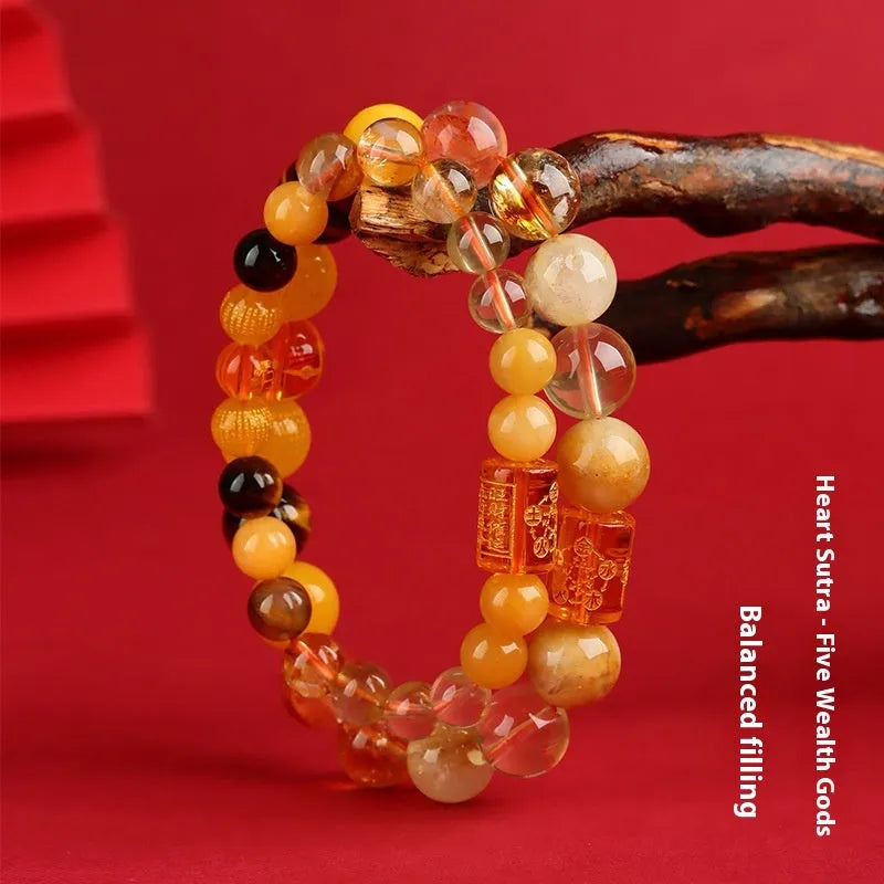 Handmade five elements crystal bracelet in gold, wood, water, fire, soil colours on a wrist.