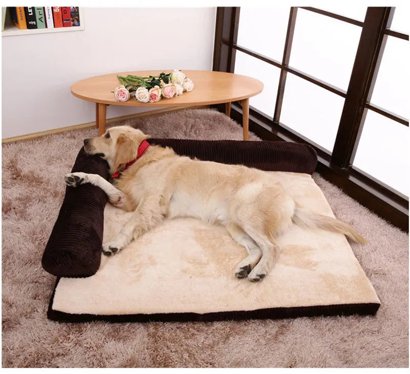 A large grey corduroy dog sofa bed with bilateral sides and a non-slip base on a wooden floor.