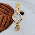 Women's stainless steel watch with round dial showing gold surface and vachette clasp